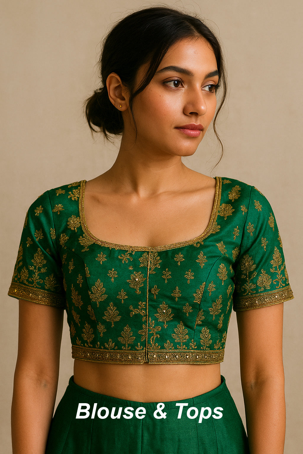 South Asian woman wearing a vintage emerald green silk blouse with intricate gold embroidery, styled traditionally against a soft neutral background.